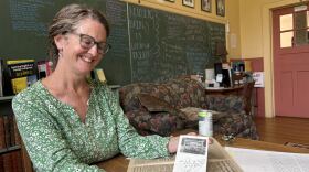 Terri Wells shows a brochure created by local women in Sandy Mush for the 1980s anti-nuclear waste dump campaign.