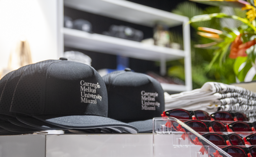 Carnegie Mellon University Miami-branded hats sit on display at an event celebrating the opening of the satellite campus in the Wynwood district. Thursday, Oct. 1, 2026, in Miami, Fla.