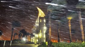 Trees sway from heavy rain and wind from Hurricane Matthew in front of Exploration Tower early Friday, Oct. 7, 2016 in Cape Canaveral, Fla. Matthew weakened slightly to a Category 3 storm with maximum sustained winds near 120 mph, but the U.S. National Hurricane Center says it's expected to remain a powerful hurricane as it moves closer to the coast. (Craig Rubadoux/Florida Today via AP)