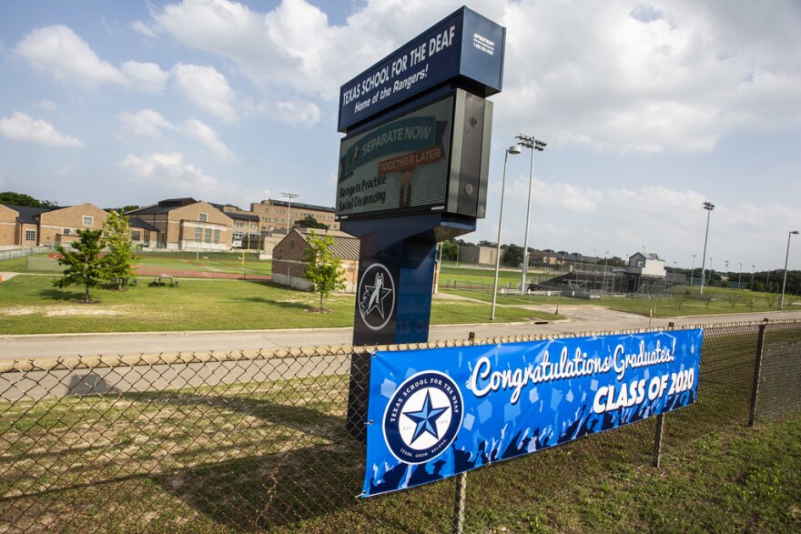 A sign outside the Texas School for the Deaf congratulates the graduating class. 