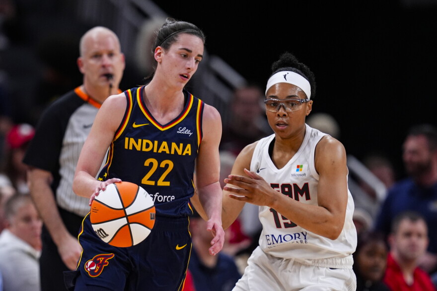 Indiana Fever guard Caitlin Clark (22) drives on Atlanta Dream guard Allisha Gray (15) during the first half of a preseason WNBA basketball game in Indianapolis, Thursday, May 9, 2024.