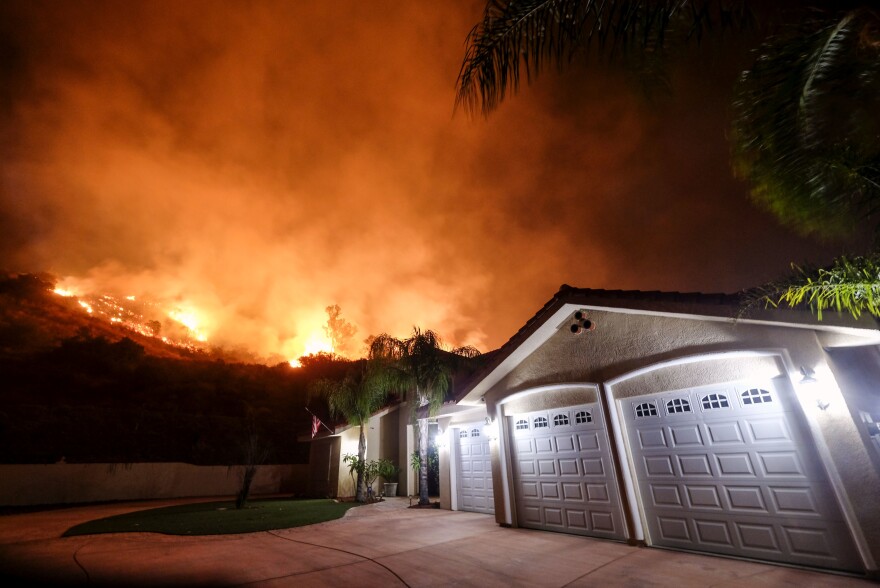 The Holy Fire burns near homes in the Cleveland National Forest in Lake Elsinore, Calif., Thursday, Aug. 9, 2018. (AP Photo/Ringo H.W. Chiu)