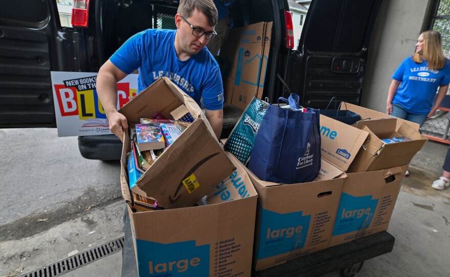 Josh Perry works to unload books as part of the Leadership Northeast group New Books on the Block at the Luzerne County Correctional Facility.
