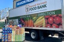 A pallet of food next to a Second Harvest truck.