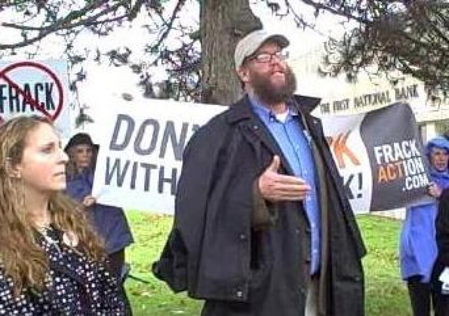 Anti-fracking activists speak to a crowd gathered outside Selig Hall on the Sullivan County Community College Campus.