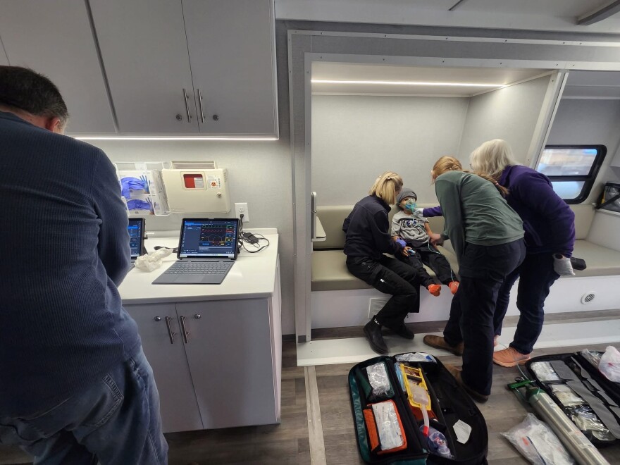 Two instructors lead Hinsdale County EMS students in a simulated training.