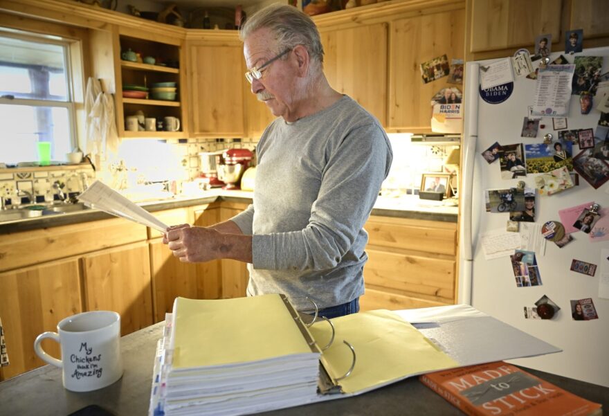 Don Schreiber looks over paperwork from a years-long battle with Hilcorp Energy about a spill on his ranch. (Jerry Redfern/Capital & Main)