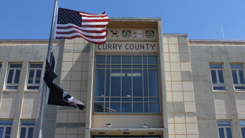 The Curry County Administrative Annex building, with American flag flying in front of the building and "Curry County" displayed above the entrance.
