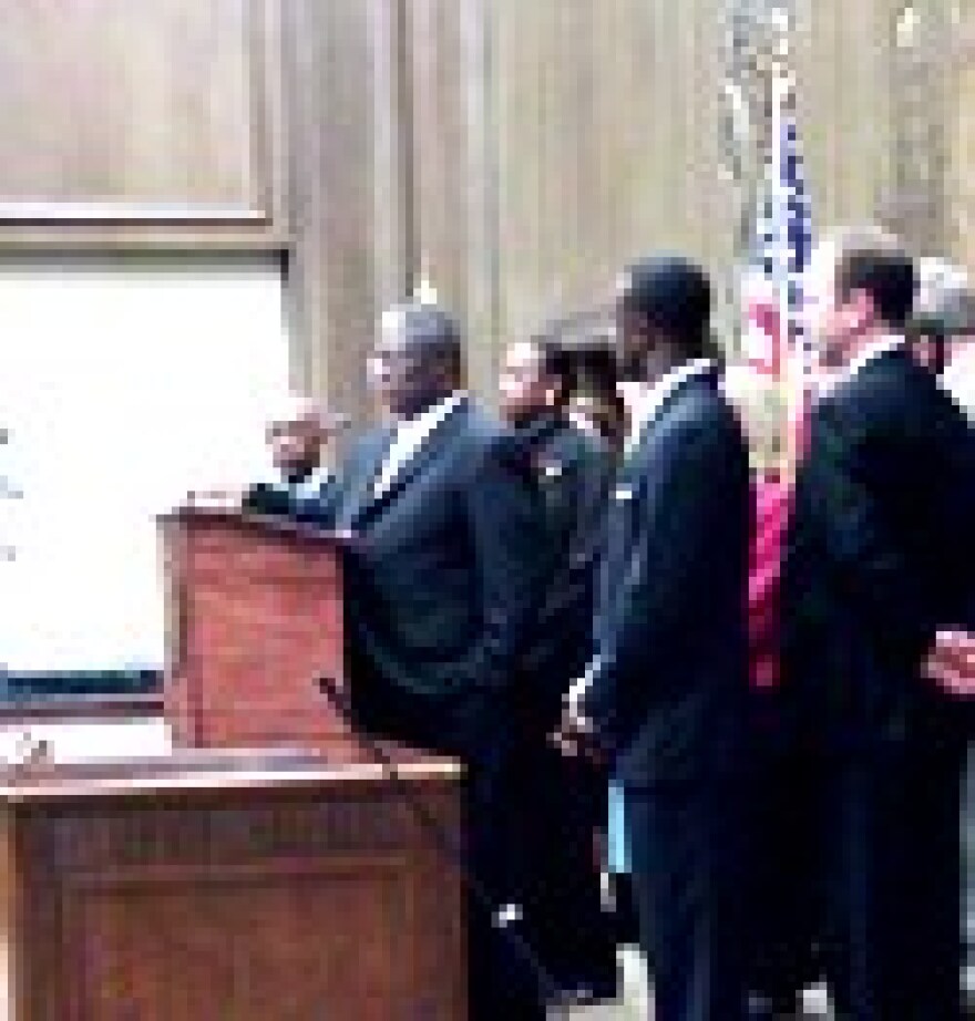 Mayor-Elect Sly James in midst of his new City Council at City Hall.