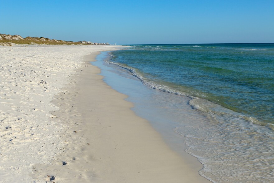 A pristine beach and a cloudless sky