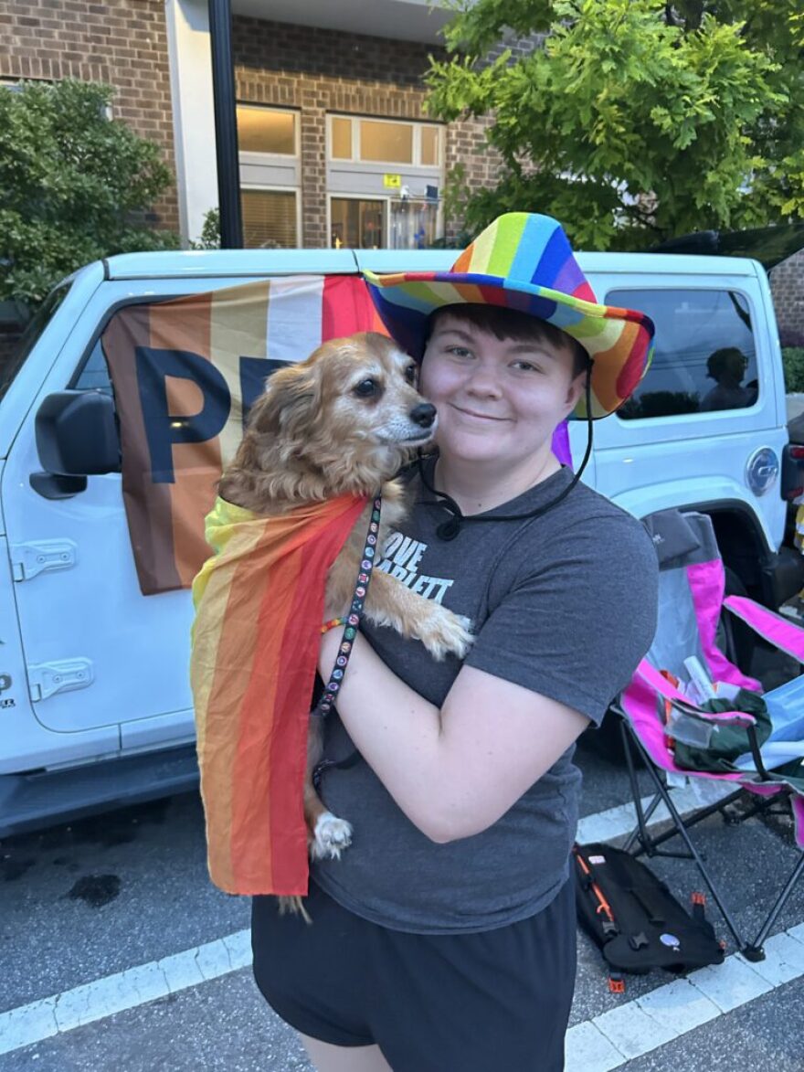 Parade-goer Katie White holds a dog.