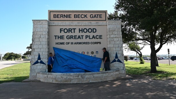 From left, Sohail Salgado, work reception technician, Fort Hood Directorate of Public Works, Operations and Maintenance Division, and Stephen Short, air-conditioning mechanic, DPW, OMD, drop a tarp at the Bernie Beck Gate sign to reveal the new name of the installation during the commemorative renaming ceremony July 28, 2025, at Fort Hood, Texas. (U.S. Army photo by Janecze Wright, Fort Hood Public Affairs)