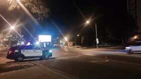 Squad car with lights flashing blocking entrance to the 500 block of north Center in downtown Bloomington.