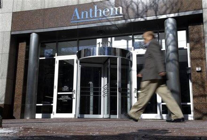 A man walks past health insurer Anthem's corporate headquarters in Indianapolis, Thursday, Feb. 5, 2015. Hackers broke into the company's database storing information for about 80 million people in an attack bound to stoke fears many Americans have about the privacy of their most sensitive information