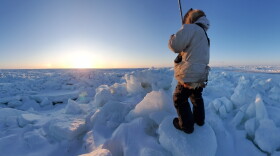 Alaska Arctic Observatory and Knowledge Hub observer Guy Omnik watches from land-fast sea ice near Point Hope, Alaska.