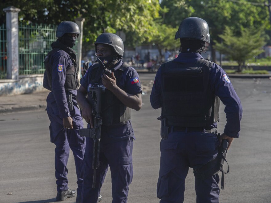 Armed forces secure the area where Haiti's Prime Minister Ariel Henry placed a bouquet of flowers in front of a memorial to independence hero Jean-Jacques Dessalines in Port-au-Prince, Haiti, on Sunday. Haitian police are working with U.S. officials and are in contact with the kidnappers who abducted a group of American-based missionaries on Saturday.