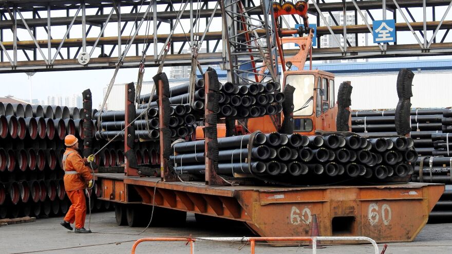 A Chinese worker loads steel tubes onto a truck in China's Jiangsu province in 2016. The Trump administration is considering imposing steep tariffs on imported steel and aluminum.