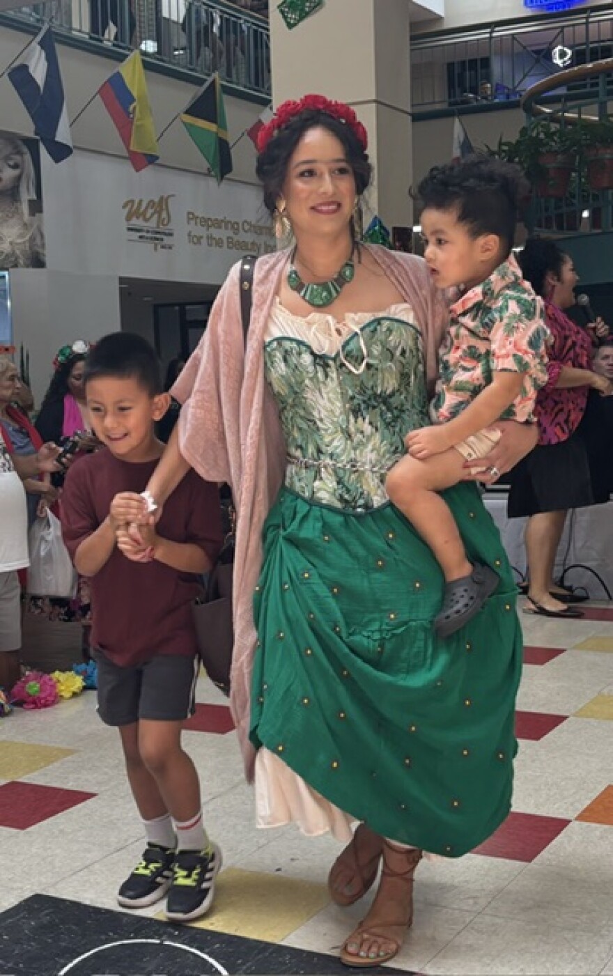 A mom dressed as Frida Kahlo joins the parade of Fridas at Frida Fest on Aug. 15, 2026.