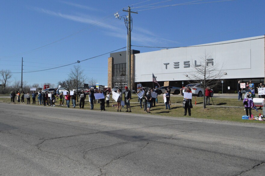 Protestors gather in front of Tulsa's Tesla store on Saturday, March 22, 2025.