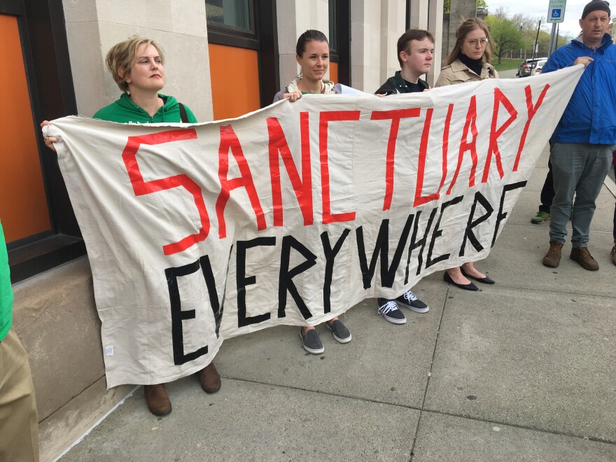 Immigrant advocates display a banner that reads ''sanctuary everywhere." File photo.