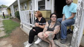 People who live in Brookhill Village, at South Tryon Street and Remount Road, are worried as they watch workers tear down parts of  the 67-year-old development all around them. Iya Jarouss, left, Cecillia Brunell, and Jeff Pegg sit on the front porch. 