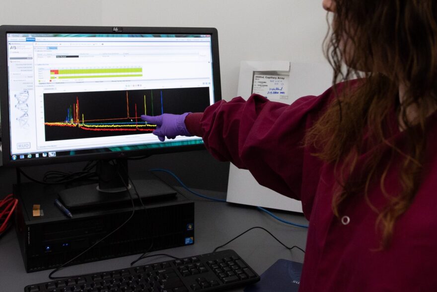 Rhonda Williams, a criminalist for the Combined DNA Index System unit at the Oklahoma State Bureau of Investigation, points to an example of DNA analysis similar to DNA analyses of hair.