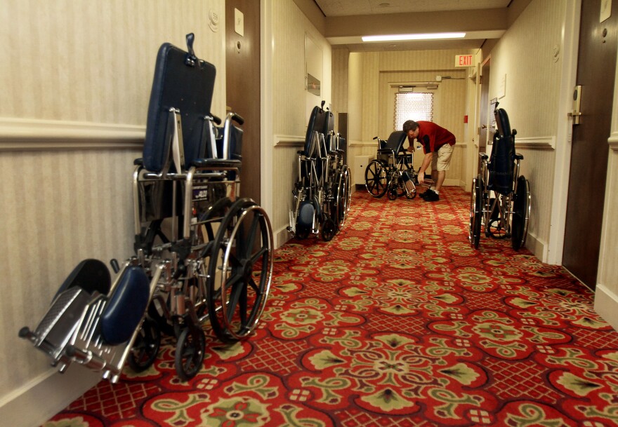 Mayo Clinic employee Kevin Acker collects wheelchairs from a hallway at the Kahler Grand Hotel in Rochester. He retrieves abandoned chairs around the city every weekend.