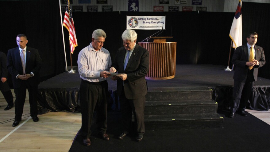 Newt Gingrich signs an autograph for supporter Jeff Legg as members of the Secret Service look on at Delmarva Christian High School in Georgetown, Del., on April 18.