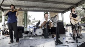 FILE - Savoy family members, Joel Savoy on fiddle, his father, Marc Savoy, on accordion and mother, Ann Savoy, play traditional Cajun music mixed with some contemporary tunes, Sept. 17, 2005, at the Festivals Acadiens in Lafayette, La.
