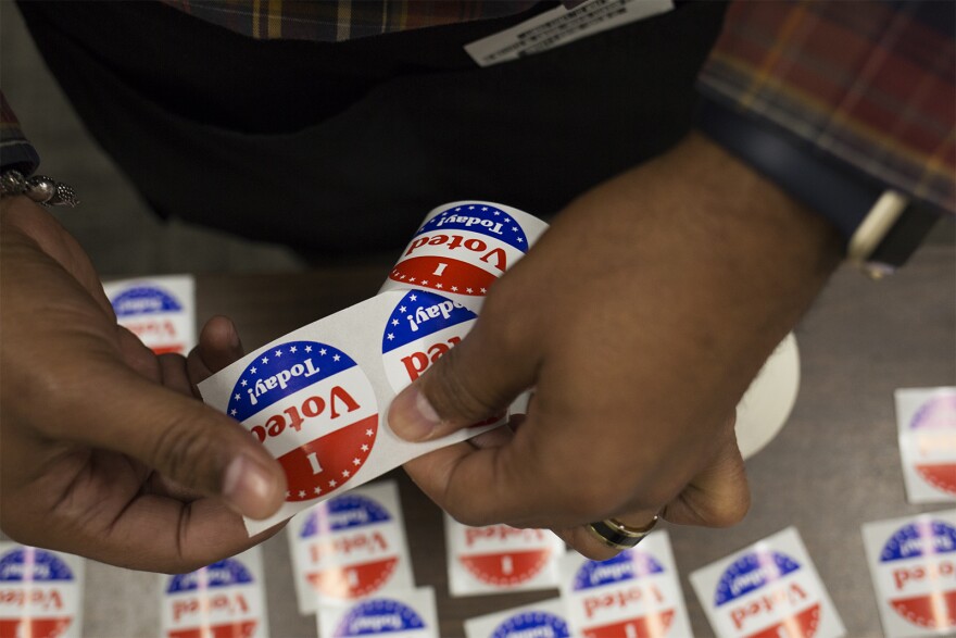 A poll worker sets out "I voted today" stickers at the St. Louis County Board Of Elections on Oct. 25.