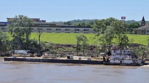 The tugboat Florence T pushes a 72-by-180-foot barge carrying the first crane to be used in constructing the Brent Spence Companion Bridge.