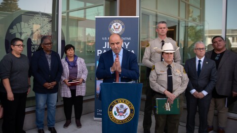 Congressman Jimmy Panetta stands at a podium in Santa Cruz surrounded by other local leaders