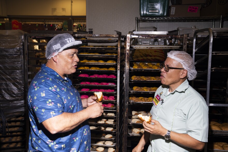 Mando Rayo and Manny Colunga taste fresh conchas baked at the Mi Tienda panaderia.