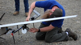 Jason Williams removes containers filled with water from a drone at Furie Operating Alaska’s central processing facility.