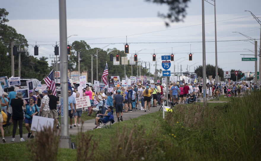 People gather along U.S. 41 in Fort Myers on Saturday morning, October 17, 2026, to advocate for change ahead of the mid-term elections. Organizers estimate about 1,000 people came out for the event.