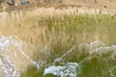 A drone view shows petroglyphs carved into the rock surface at Pōkaʻī Bay, July 22, 2025, in Waiʻanae, Hawaiʻi.