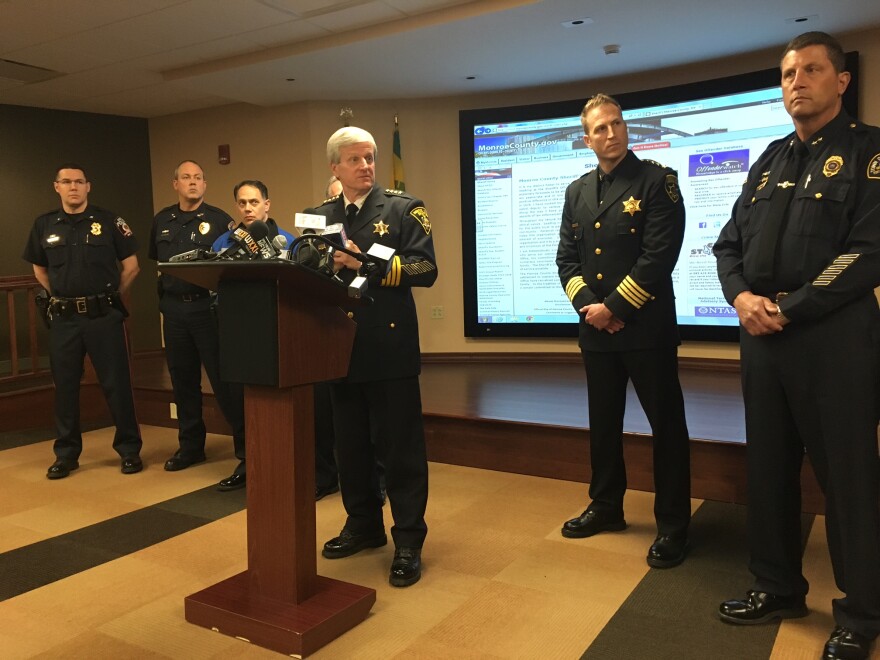 Monroe County Sheriff Patrick O'Flynn (center) announces the implementation of Offender Watch tracking system.