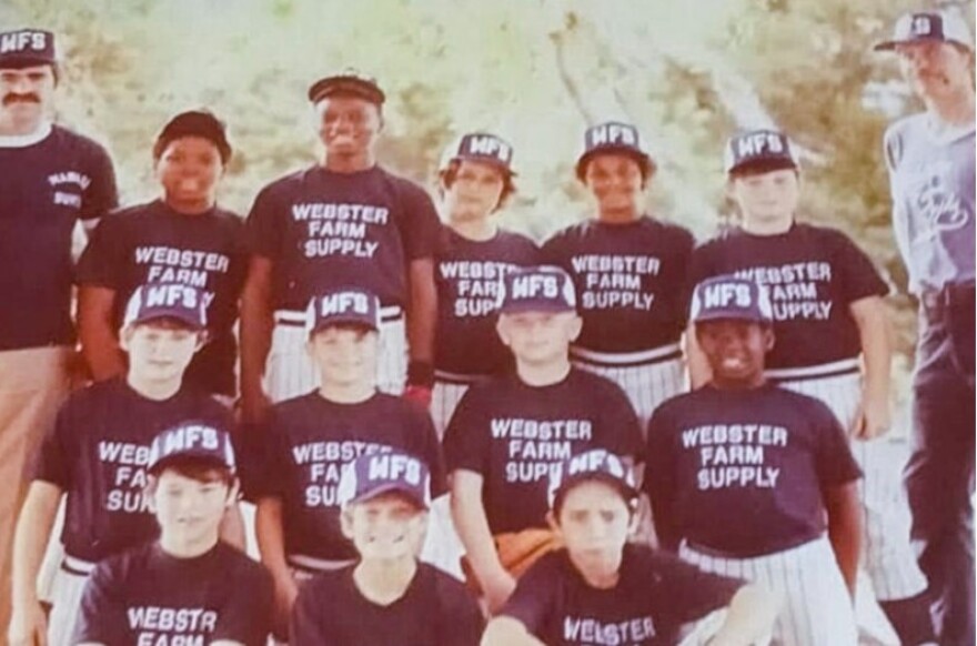 Boys on a Little League team posing for a team photo