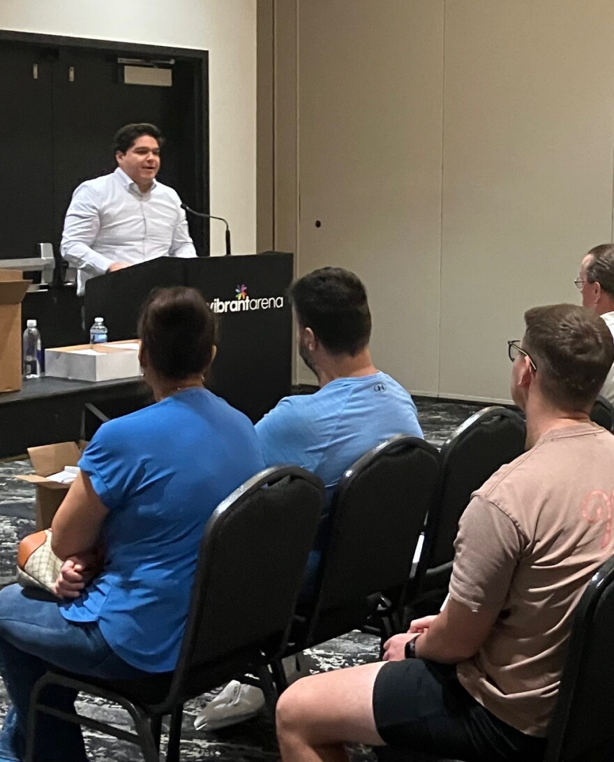 Andres Mendez of the U.S. Department of Labor explains health insurance options to laid-off Tyson workers on Sept. 2 at Vibrant Arena, Moline.