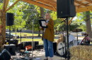 Indivisible Evansville President Wendy Bredhold speaks from the stage at Vote Fest in Evansville's Vann Park, Oct. 18, 2026