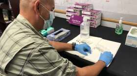 A Florida Department of Health worker puts together a kit. Photo: Danielle Prieur