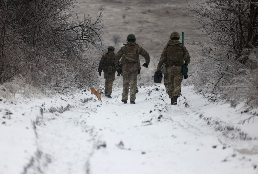 Ukrainian soldiers walk along a road not far from the Russian-occupied Ukrainian city of Bakhmut, Donetsk region, on Dec. 13.