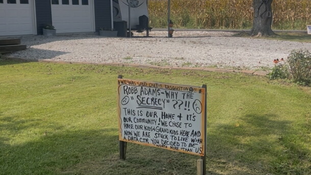 A handwritten yard sign questioning the "secrecy" around a proposed hyperscale data center next door sits in a front yard on Greens Bottom Road in Carroll County.