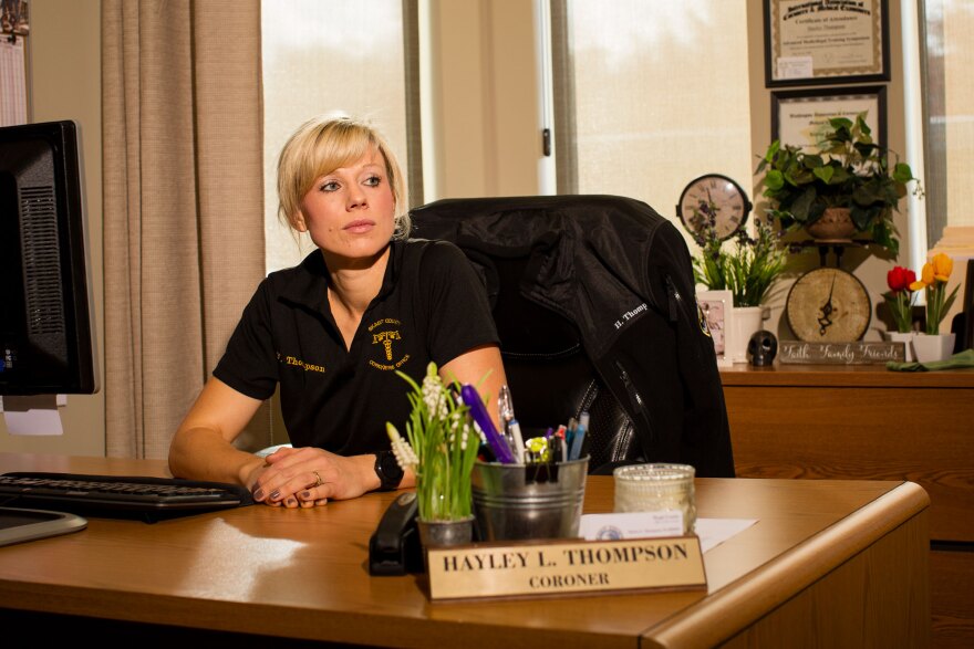 Hayley Thompson sits at her desk inside the Skagit County Coroner's Office in Mount Vernon.