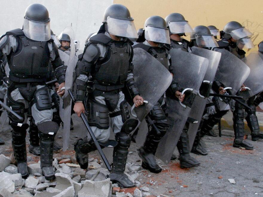 Policemen charge on protesters in San Salvador Atenco, Mexico, in May 2006, in efforts to reestablish order in the city. Two people died and many were abused in the battle that broke out when police attempted to remove peddlers from the city and neighboring Texcoco.
