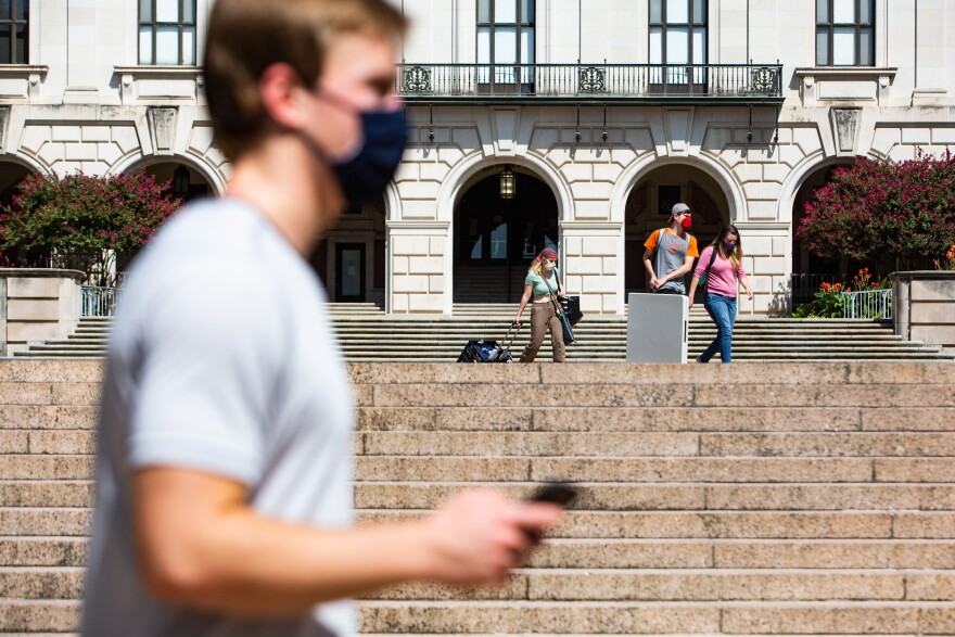  Students, some wearing protective face masks, on the campus of the University of Texas at Austin on Oct. 1, 2020.