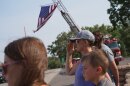 A woman salutes during a procession for firefighters who died battling wildfires near the Colorado-Utah border in Grand Junction, Colo., June 29, 2026.