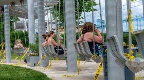 Ignoring social distancing protocol and regulations, people have taken to tearing down the caution tape that once cordoned-off public swings along the Ohio River at Smale Waterfront Park in the wake of the coronavirus pandemic on May 16, 2020.