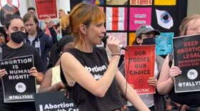 Lauren Brenzel with Planned Parenthood of Florida speaks to protestors gathered to rally for access to abortion care. (Regan McCarthy /WFSU News)