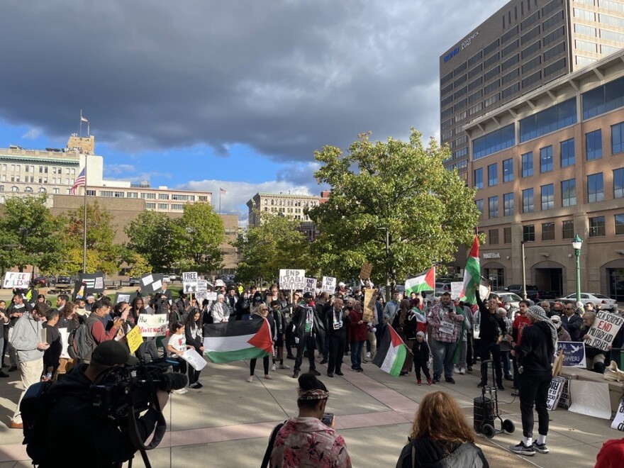 A crowd gathers on the federal building plaza in downtown Syracuse before marching to Columbus Circle Oct. 13, 2023.